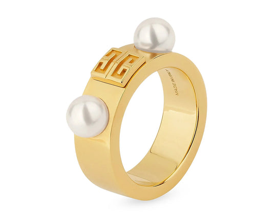 Gold ring with two pearls on a white background
